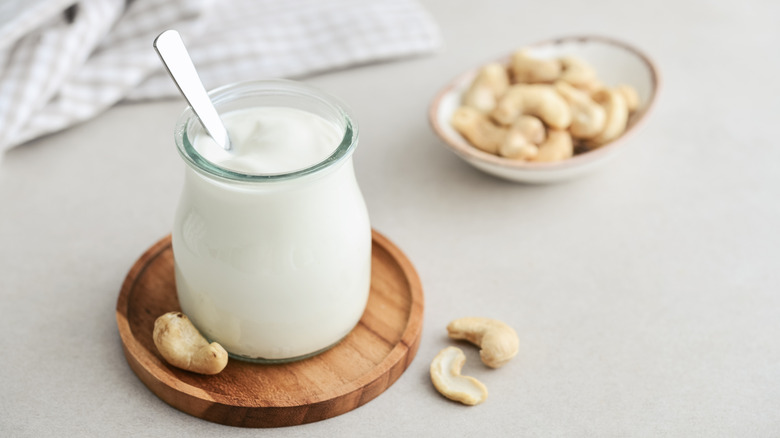 Cashew cream in jar and whole cashews