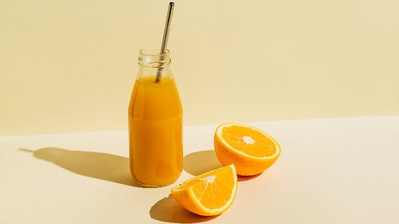 jar of orange juice and oranges