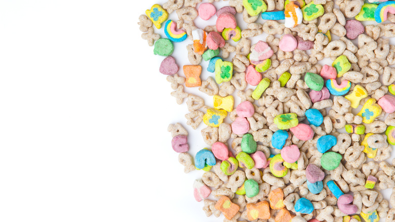 a white background half covered with marshmallow cereal