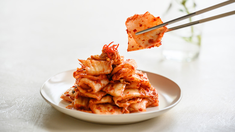 Chopsticks picking up kimchi