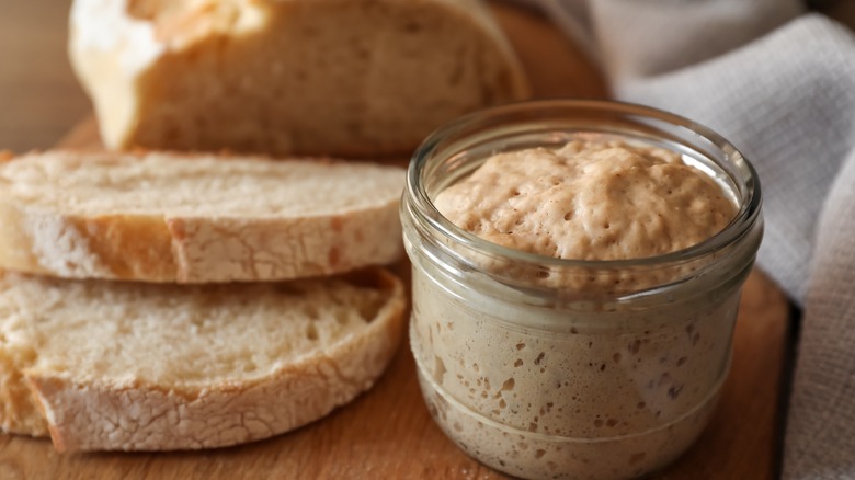 Sourdough starter next to bread