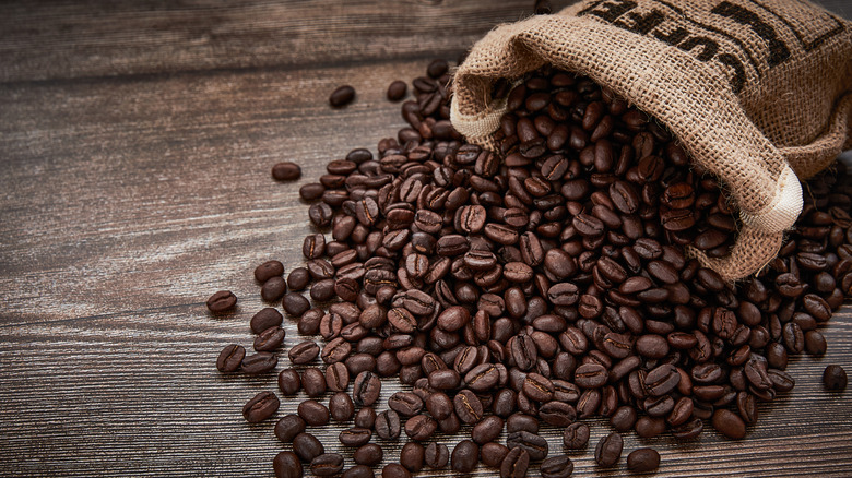 Coffee beans spilling out from a burlap sack