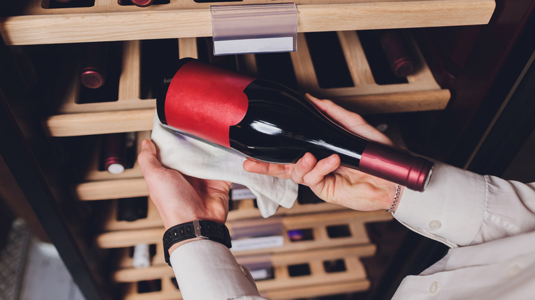 wine bottle removed from shelf