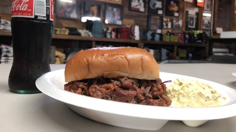 Brisket sandwich with Coke and sides