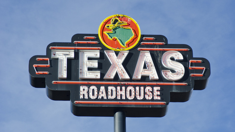 Texas roadhouse sign against a sky