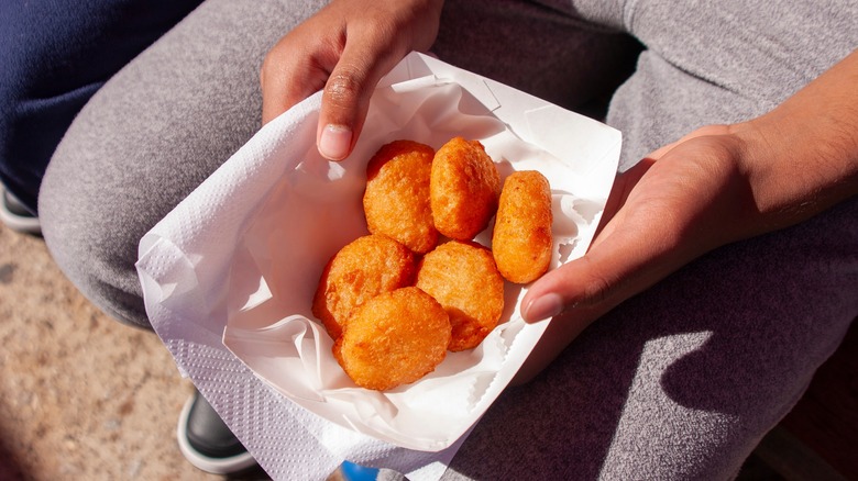 Person holding fried food at the Texas State Fair