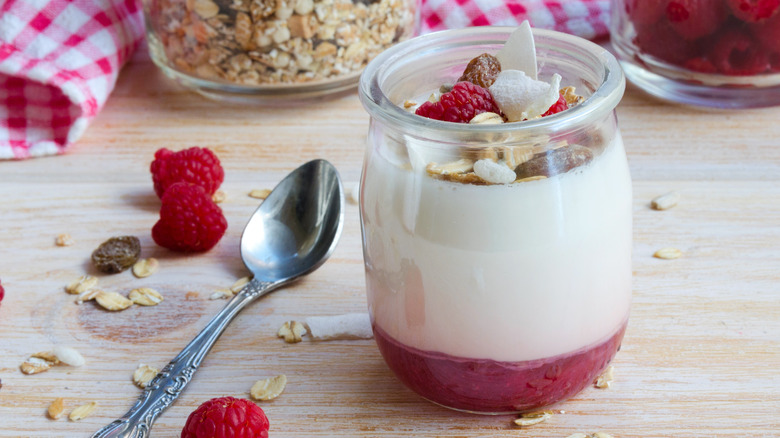 Raspberries at the bottom of a yogurt cup