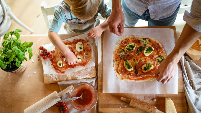 Family making pizzas together