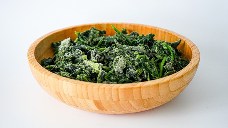 Wooden bowl of frozen greens