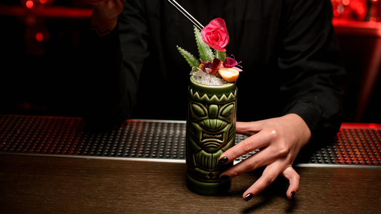 bartender serving a tiki drink 