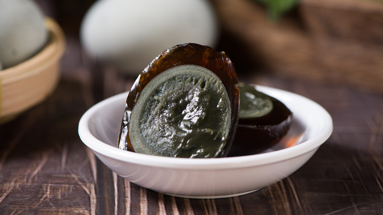 halved century egg in a small white bowl