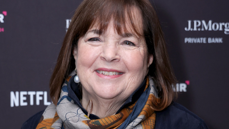 Ina Garten smiling in scarf and pearl earrings