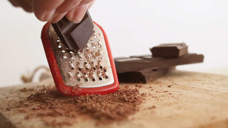 grating chocolate on a cutting board