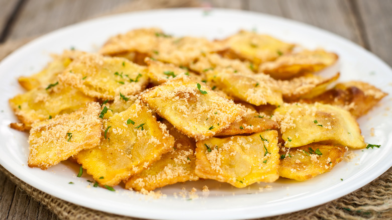 Toasted ravioli on a white plate