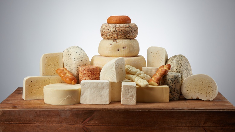 Assorted cheeses on wooden board