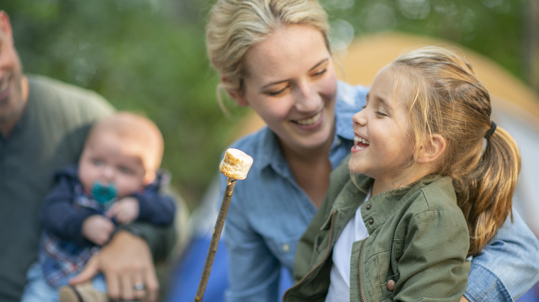 Family with marshmallow on stick