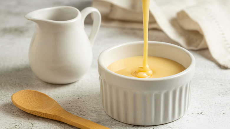 Sweetened condensed milk pouring into a bowl