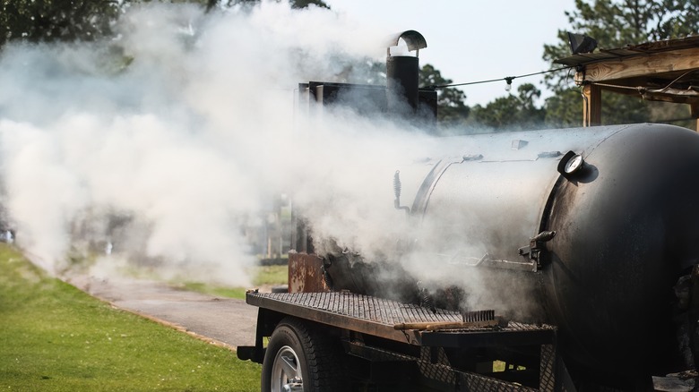 Barbecue smoker billowing smoke