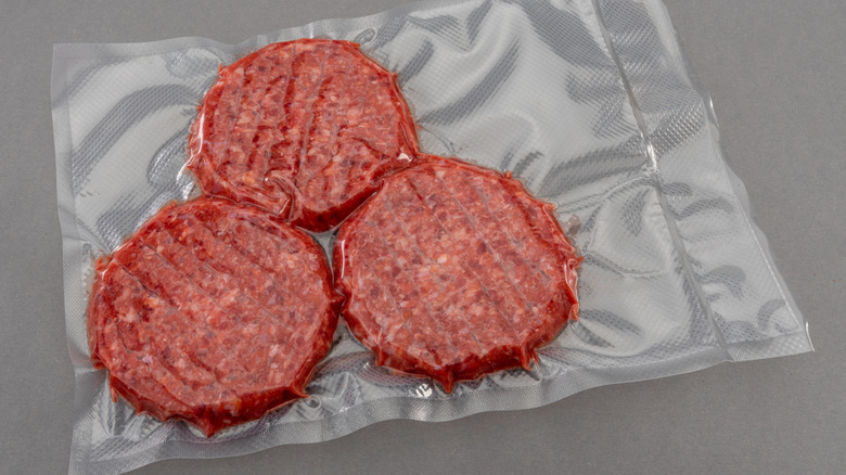 Three raw burger patties in a bag ready to be sous vide