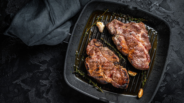 Pork shoulder steaks on a grill pan