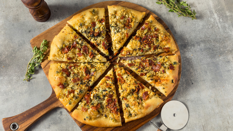 Clam pizza on wooden serving tray