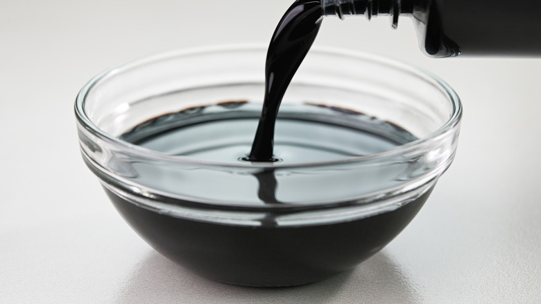 Pouring soy sauce into a bowl