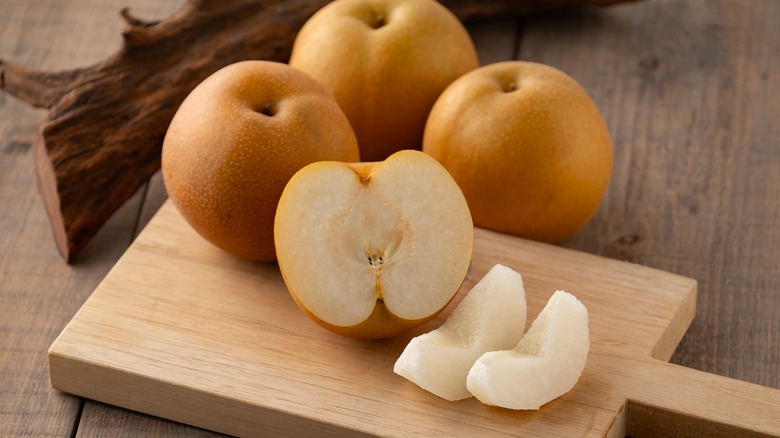 Asian pears on wooden board