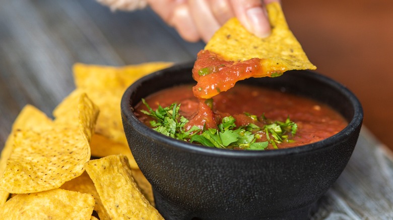 dipping chip into salsa