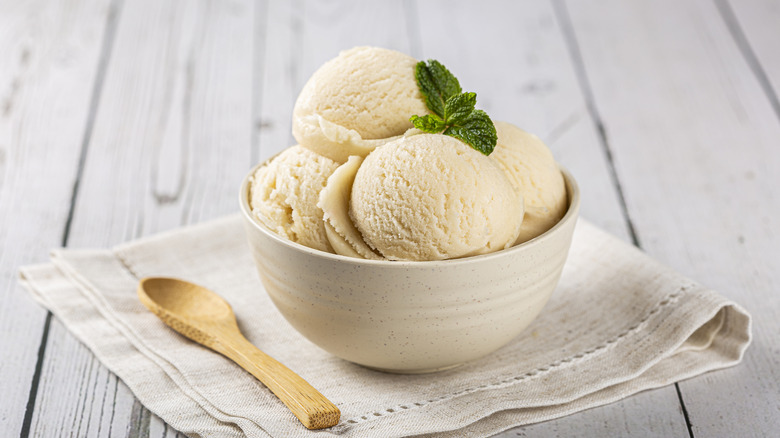 Bowl of vanilla ice cream sitting on a table