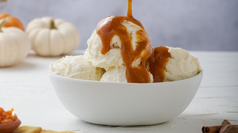 Pumpkin syrup drizzled over vanilla ice cream