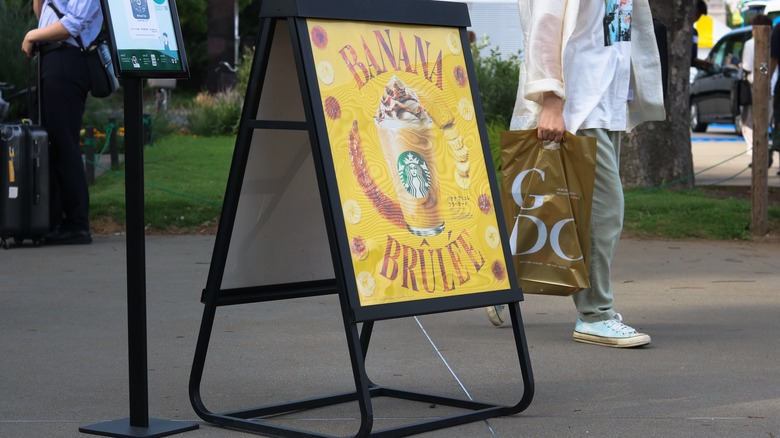 Starbucks Banana Brulee drink sign on the sidewalk