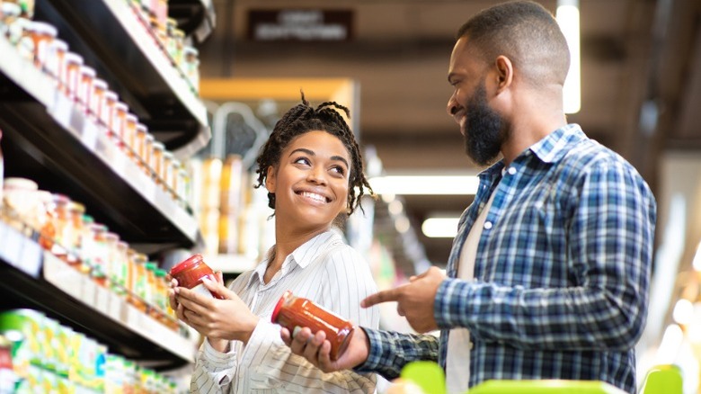 Couple reading ingredients together at store