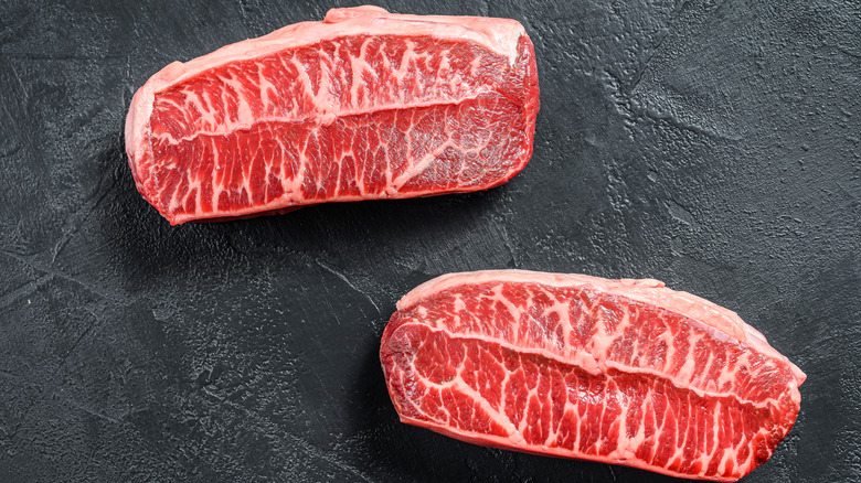 Marbled steak on cutting board