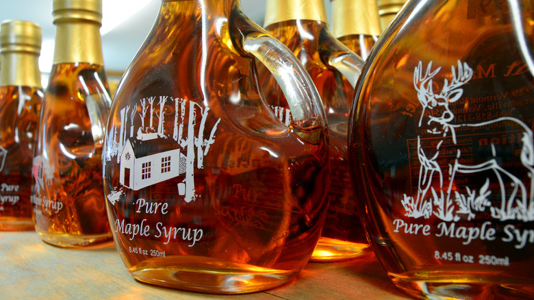 Glass bottles of maple syrup in a row