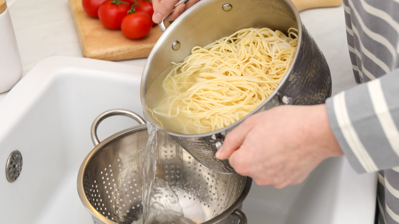 Straining pasta with a colander