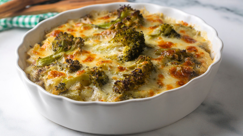 Broccoli cheese casserole in white baking dish