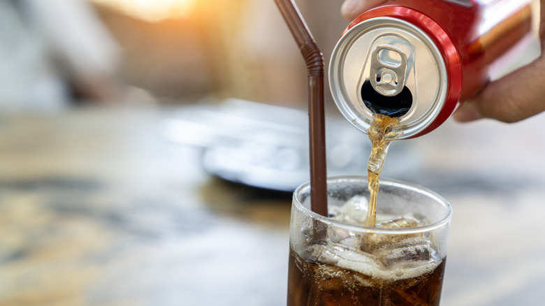 Pouring soda into glass