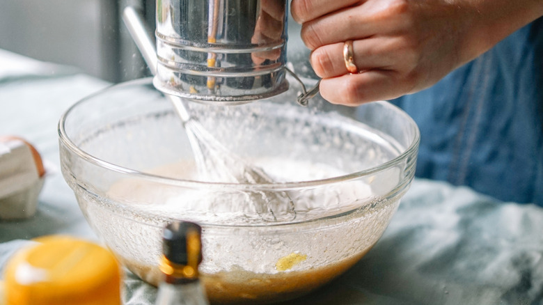 Person mixing ingredients in a bowl