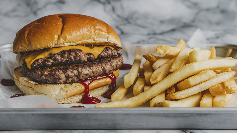 Hamburger and french fries on tray