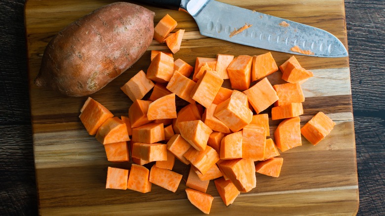 Chopped sweet potatoes on cutting board