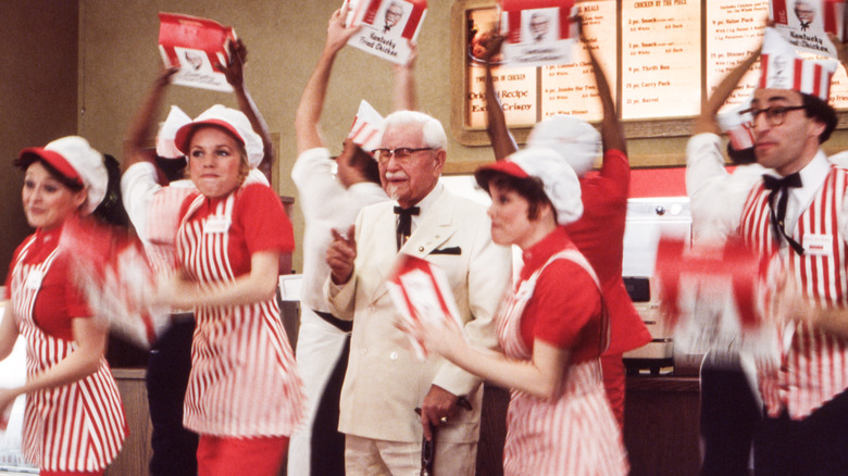 Sanders with dancers in KFC uniforms
