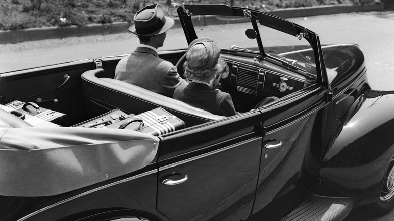 1940's photo of couple driving car