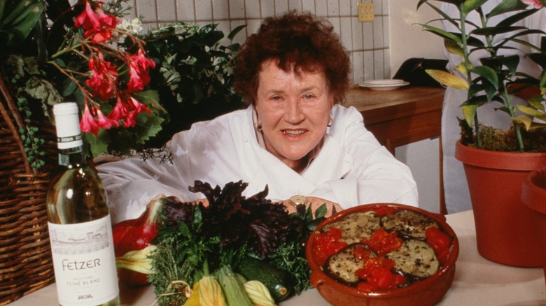 French cook Julia Child smiling with her dishes