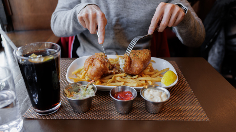 Person eating fish and chips