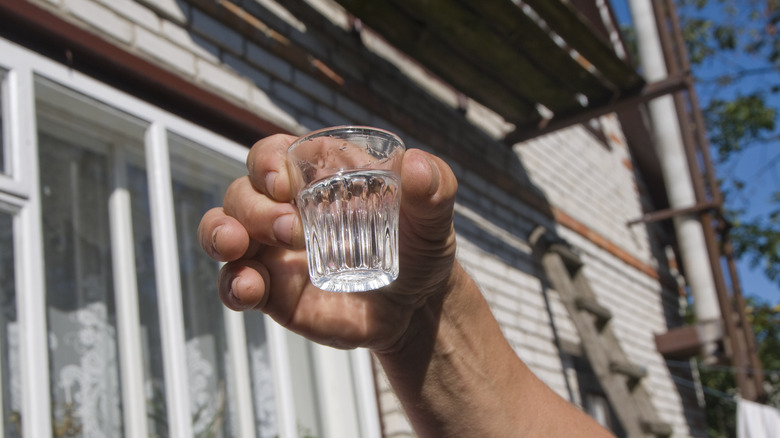 man holding shot glass