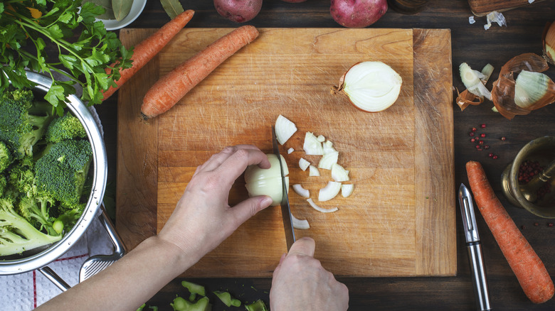 Chopping vegetables on a wooden cutting board