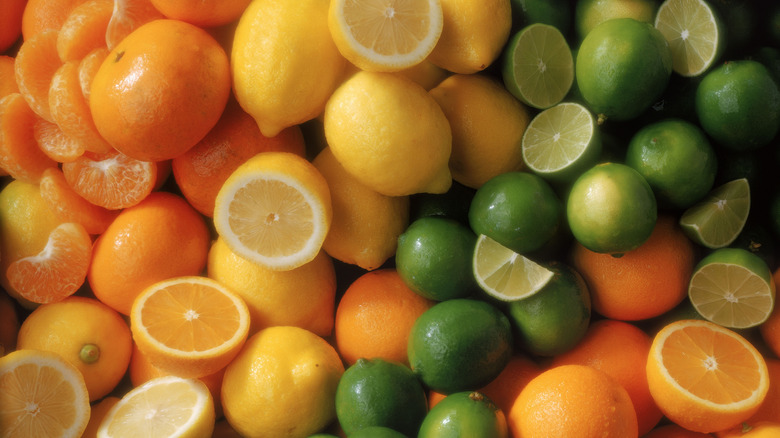 Assorted citrus fruits, whole, sliced, and sectioned