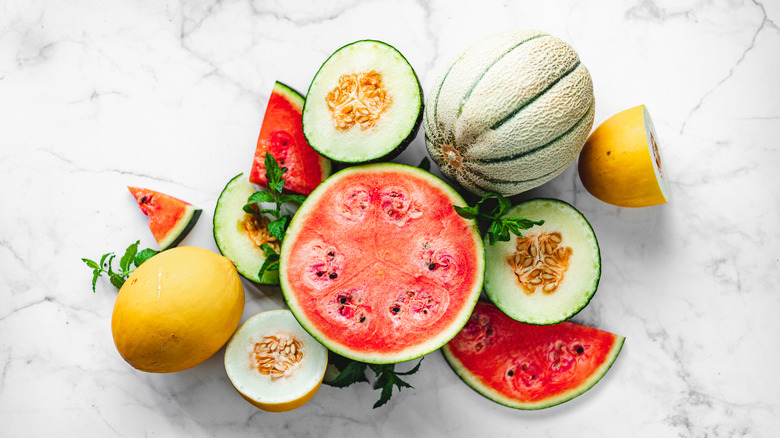 Various types of whole and sliced melons