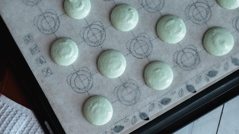 Macaron batter resting on parchment to form a skin