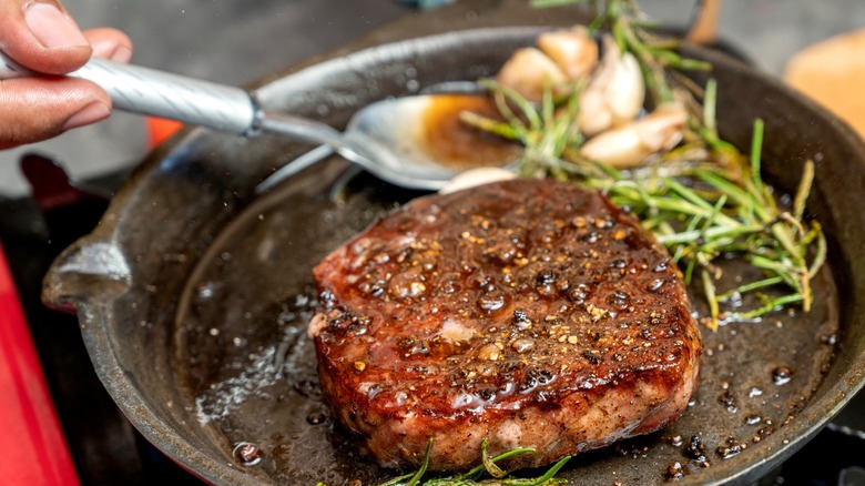 steak placed into frying pan